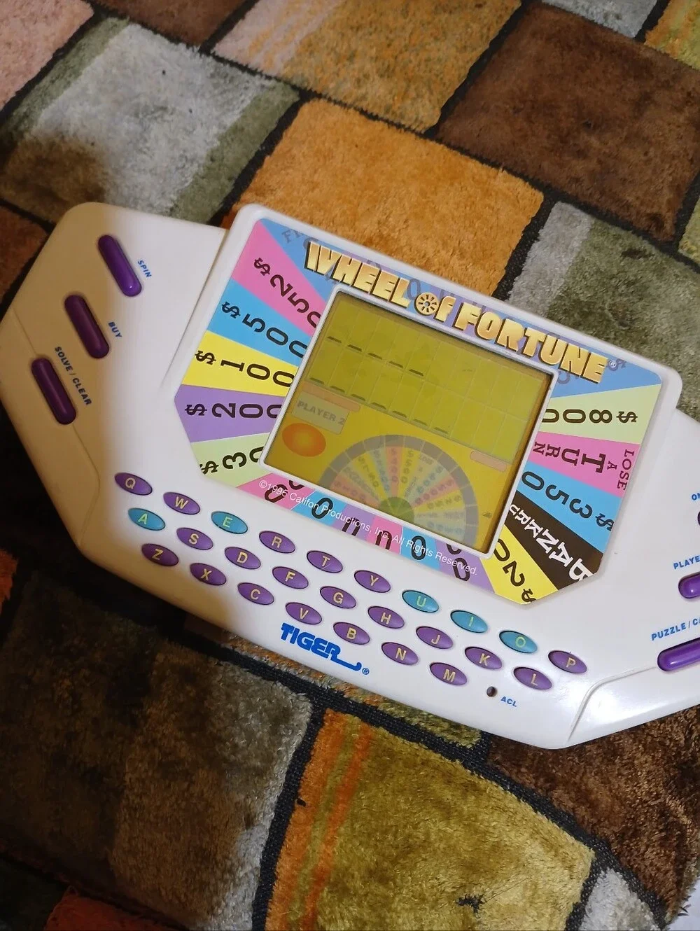 Tiger Electronics Wheel of Fortune Handheld Game - White with Purple Keys